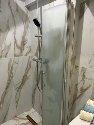 a shower with a glass door in a bathroom at Normandy in Cannes
