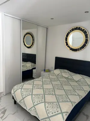 a bedroom with a bed and two mirrors at Normandy in Cannes