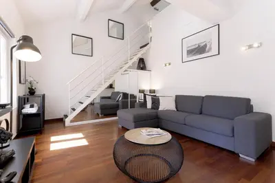 a living room with a couch and a table at Rue Lafontaine by Halldis in Cannes