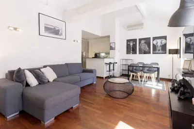 a living room with a couch and a table at Rue Lafontaine by Halldis in Cannes