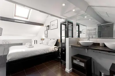 a bedroom with two sinks and a large bed at Rue Lafontaine by Halldis in Cannes