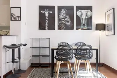 a dining room with a table and three chairs at Rue Lafontaine by Halldis in Cannes