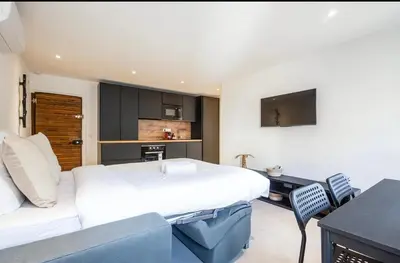 a hotel room with a large bed and a desk at 2 Pcs Plein Coeur Ville, Palace Festivals, Port Plages in Cannes