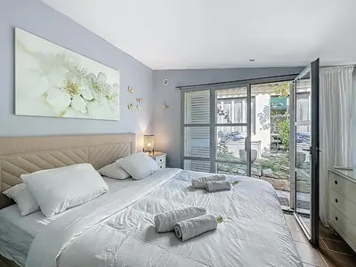 a bedroom with a large bed with two pillows on it at 126m2 - maison plage, 3 chambres, 3 salles de bain in Cannes