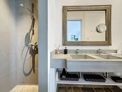 a bathroom with a sink and a mirror at 126m2 - maison plage, 3 chambres, 3 salles de bain in Cannes