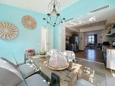 a dining room with a table and chairs at 126m2 - maison plage, 3 chambres, 3 salles de bain in Cannes