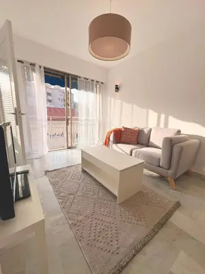 a living room with a couch and a coffee table at studio luxueux in Le Cannet