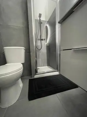 a bathroom with a shower and a toilet with a glass door at studio luxueux in Le Cannet