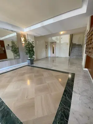 a large lobby with a marble floor and a staircase at studio luxueux in Le Cannet