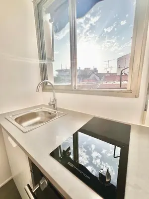 a kitchen counter with a sink and a window at studio luxueux in Le Cannet
