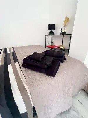 a bedroom with a bed with towels on it at studio luxueux in Le Cannet