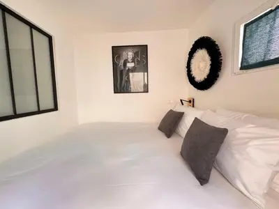 a white bedroom with a large white bed at CB Cannes- NEW YORK in Cannes