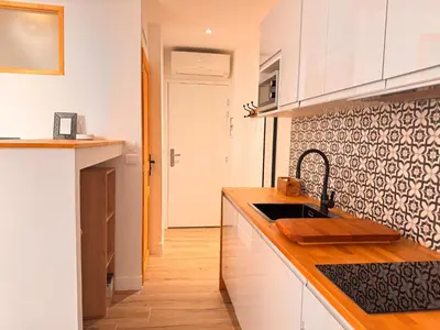 a kitchen with white cabinets and a sink at CB Cannes- NEW YORK in Cannes