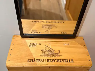 a wooden box with a bottle of chateau bysteensteensteensteensteen at CB Cannes- NEW YORK in Cannes