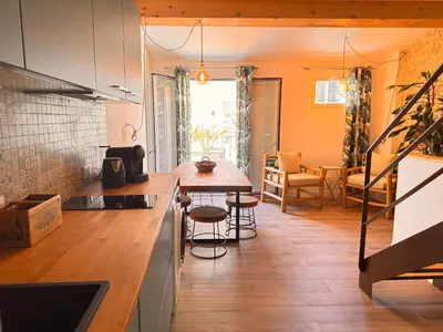 a kitchen and living room with a table and a dining room at CB Cannes - JUNGLE in Cannes