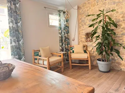 a room with a table and chairs and a plant at CB Cannes - JUNGLE in Cannes