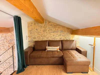 a living room with a brown leather couch at CB Cannes - JUNGLE in Cannes