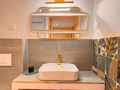 a bathroom with a white sink and a mirror at CB Cannes - JUNGLE in Cannes