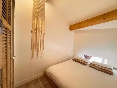 a bedroom with a bed with towels on it at CB Cannes - JUNGLE in Cannes