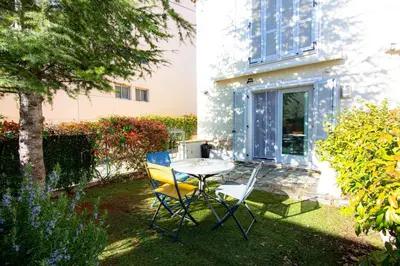 a table and chairs in the yard of a house at Le Jardin by Connexion in Cannes