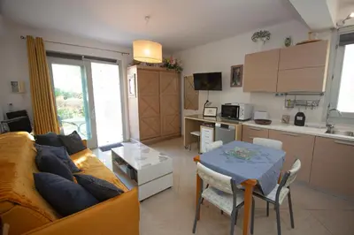 a living room with a couch and a table at Le Jardin by Connexion in Cannes