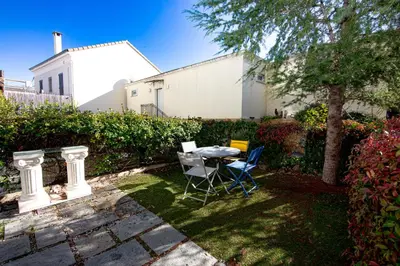 a patio with a table and chairs in a yard at Le Jardin by Connexion in Cannes