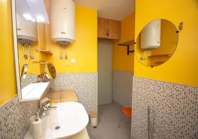 a bathroom with a sink and a yellow wall at Le Jardin by Connexion in Cannes