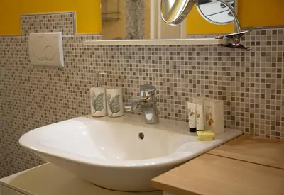 a white sink in a bathroom with a mirror at Le Jardin by Connexion in Cannes