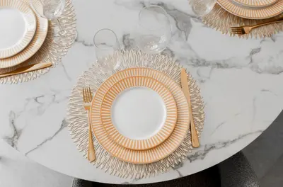 a table with plates and utensils on a marble table at T2 Neuf et chic à deux pas de la Croisette in Cannes