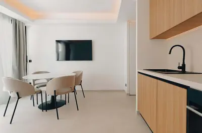 a kitchen and dining room with a table and chairs at T2 Neuf et chic à deux pas de la Croisette in Cannes
