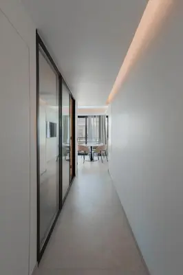 a hallway leading to a dining room with glass walls at T2 Neuf et chic à deux pas de la Croisette in Cannes