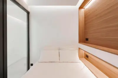 a small bedroom with a bed and a window at T2 Neuf et chic à deux pas de la Croisette in Cannes