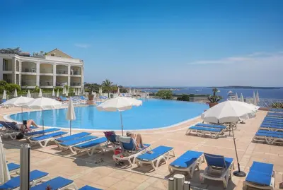 a large swimming pool with chairs and umbrellas at Villa Francia 2P with splendid pool -private rental in Cannes