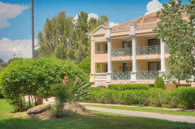a large pink building with trees in front of it at Villa Francia 2P with splendid pool -private rental in Cannes