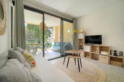 a living room with a couch and a table at Villa Francia 2P with splendid pool -private rental in Cannes