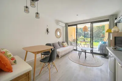 a living room with a table and a couch at Villa Francia 2P with splendid pool -private rental in Cannes