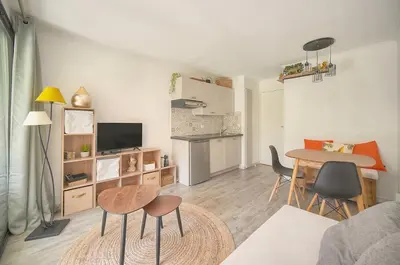 a living room with a table and chairs and a kitchen at Villa Francia 2P with splendid pool -private rental in Cannes