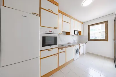 a kitchen with white cabinets and a washer and dryer at Cannes 2 bedrooms apartment - 141A in Cannes