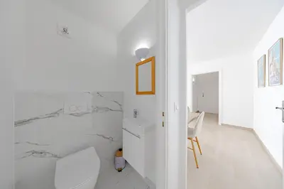 a white bathroom with a toilet and a sink at Cannes 2 bedrooms apartment - 141A in Cannes
