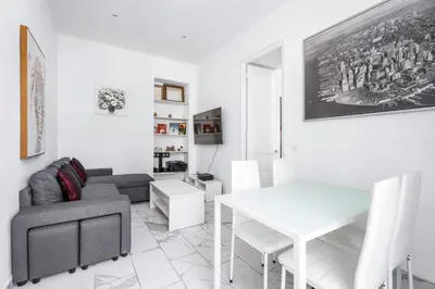 a living room with a couch and a table at Appartement Beau Site - Welkeys in Cannes