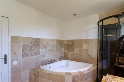 a bath tub in a bathroom with a shower at Grande villa proche plage vue îles, baie de Cannes in Cannes