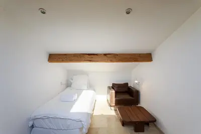 a bedroom with a bed and a chair at Grande villa proche plage vue îles, baie de Cannes in Cannes