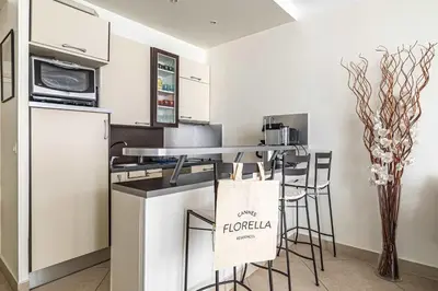 a kitchen with a counter with a microwave and a table at L'ESPRIT CROISETTE avec balcon à cote du Martinez in Cannes