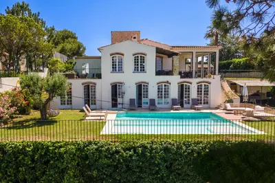 an exterior view of a house with a swimming pool at Villa exclusive au sommet de Cannes, 8 chambres, double piscine, vue sur la mer in Cannes