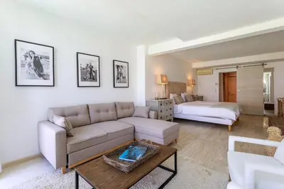 a living room with a couch and a bed at Villa exclusive au sommet de Cannes, 8 chambres, double piscine, vue sur la mer in Cannes