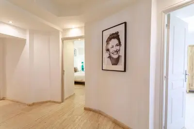 a hallway with a picture of a woman on a wall at Villa exclusive au sommet de Cannes, 8 chambres, double piscine, vue sur la mer in Cannes