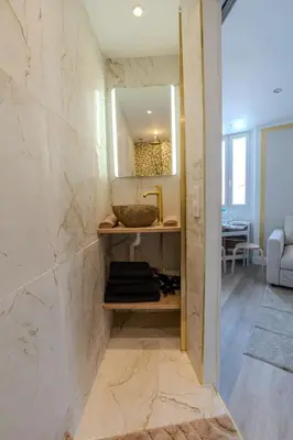 a bathroom with a sink and a mirror at Renovated 1 bedroom - AC - City Center in Cannes