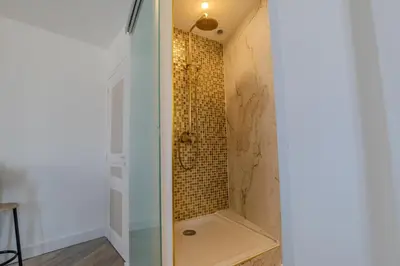 a bathroom with a shower with a glass door at Renovated 1 bedroom - AC - City Center in Cannes