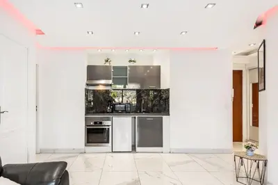 a kitchen with white walls and stainless steel appliances at Mimosas Lovers in Cannes