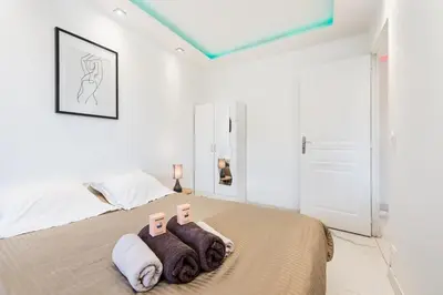 a bedroom with a bed with two towels and two candles at Mimosas Lovers in Cannes